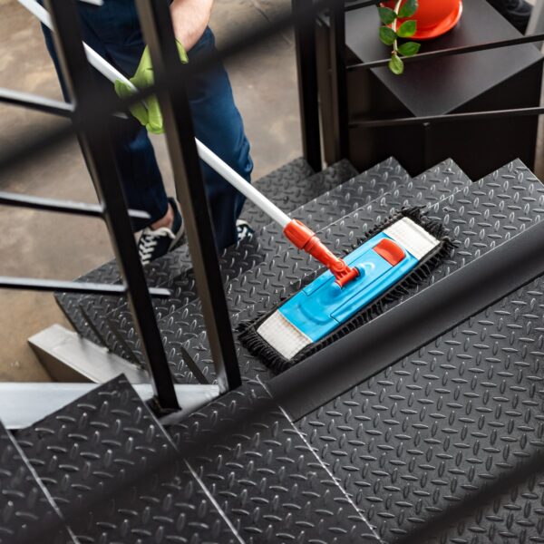 cropped view of cleaner washing stairs with mop