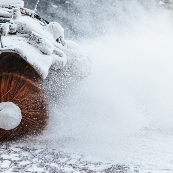 Snow plow does removal after blizzard in winter. Snow blower in motorway. Winter service on road