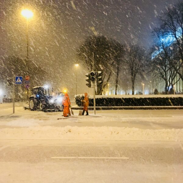 Snowy weather in the city. Utility services clean the streets of the city from snow. Winter season